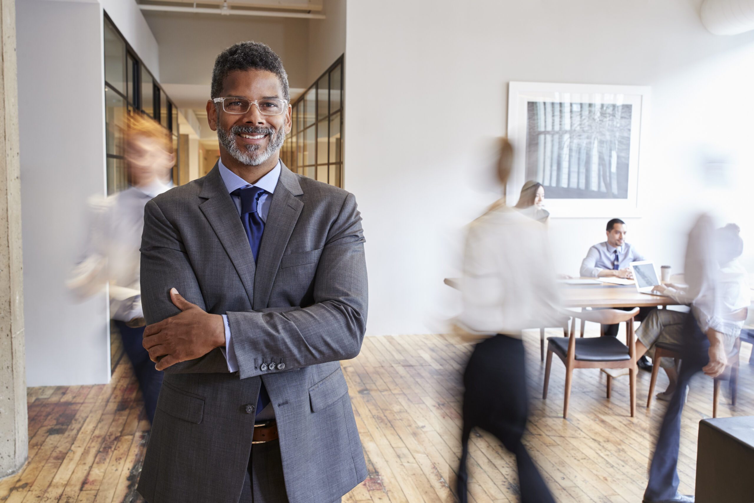 Portrait of middle aged black man in a busy modern workplace Portrait of middle aged black man in a busy modern workplace